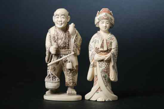 Appraisal: TWO JAPANESE IVORY OKIMONO OF MAN AND WOMAN Carved to