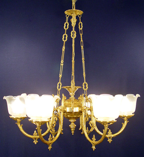 Appraisal: LIGHT BRASS CHANDELIER Ornate scroll work etched glass shades Hangs