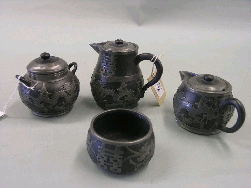 Appraisal: A Chinese four piece ceramic and pewter mounted tea set