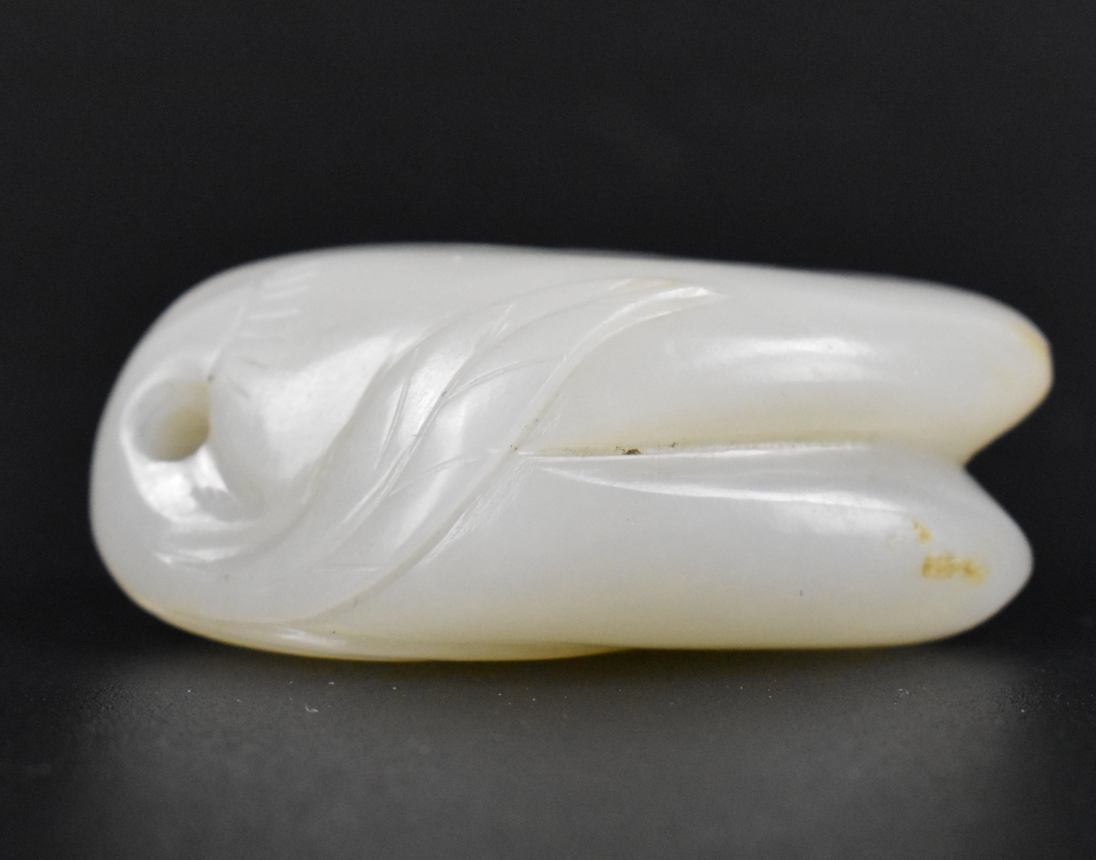 Appraisal: A fine Chinese white jade carved pendant Naturalistic form with