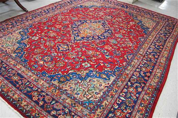 Appraisal: PERSIAN CARPET floral and central floral medallion design on red