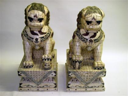 Appraisal: Pair of Large Chinese bone Fu-lionsSeated with ink-work decoration over