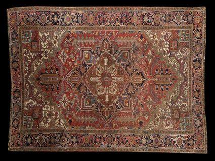 Appraisal: HERIZ MEDALLION CARPET The brick red and cobalt medallion anchored