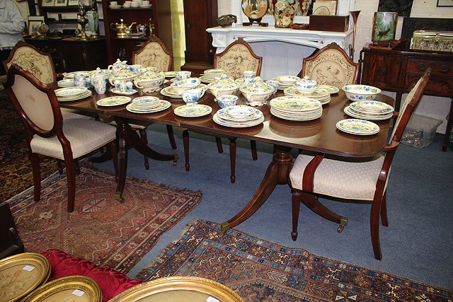 Appraisal: A GEORGE III STYLE MAHOGANY TWIN PEDESTAL DINING TABLE with