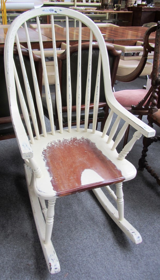 Appraisal: A th century distressed white painted Laura Ashley rocking chair