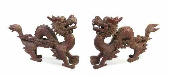 Appraisal: A Pair of Chinese Carved Wood Dragons the opposing dragons