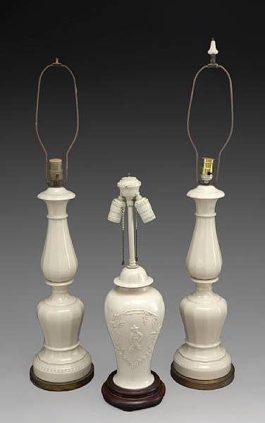 Appraisal: An assembled group of three cream glazed earthenware table lamps