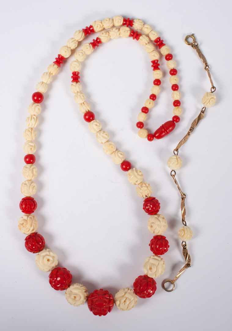 Appraisal: Red dyed and natural ivory graduated necklace in L together