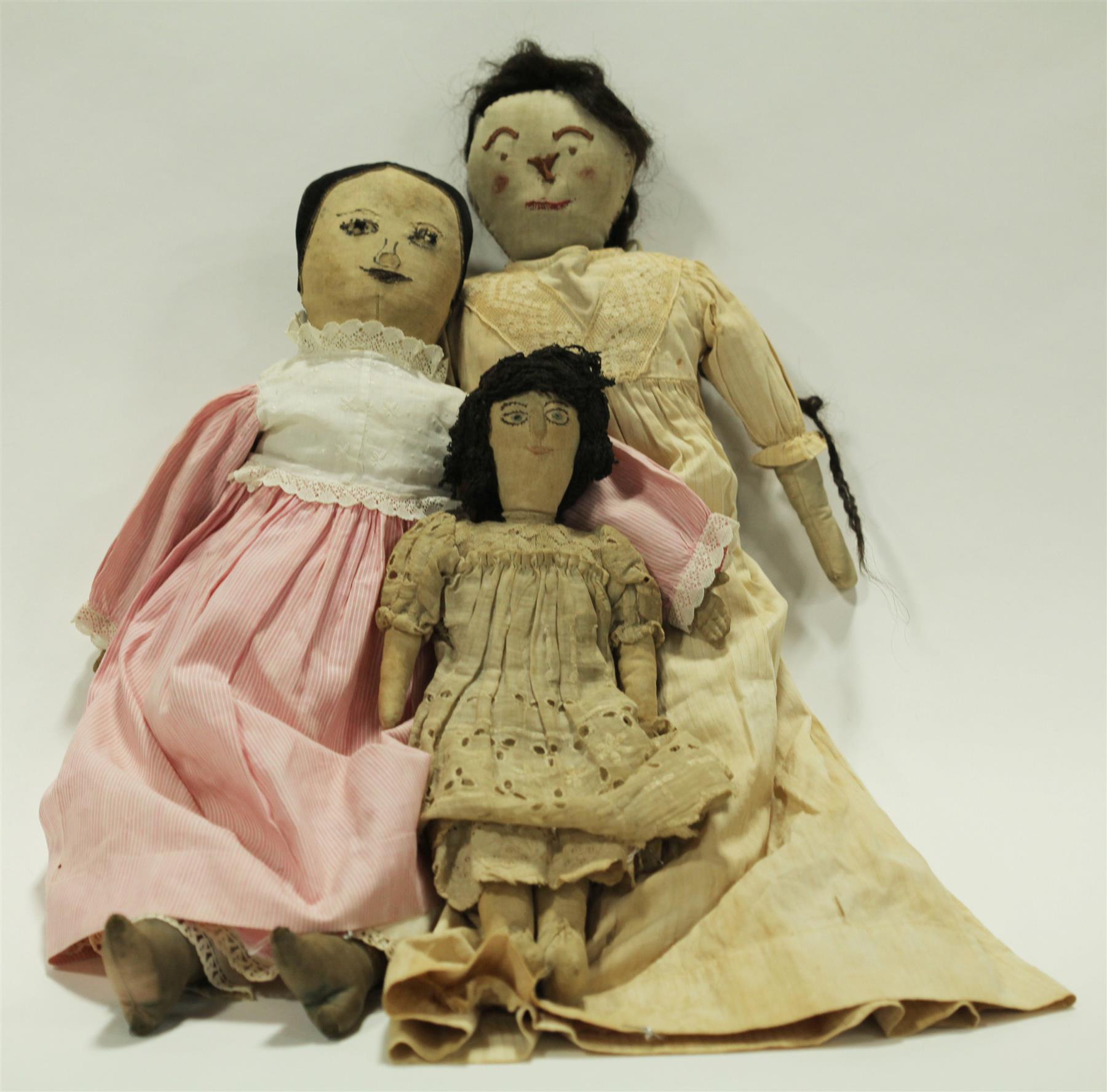 Appraisal: THREE CLOTH DOLLS WITH STITCHED FEATURES American late th century