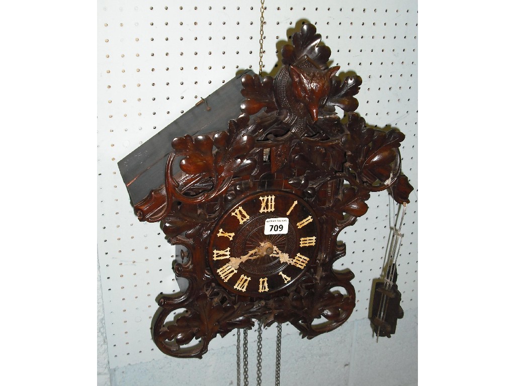 Appraisal: Black Forest cuckoo clock the dial within a foliate carved