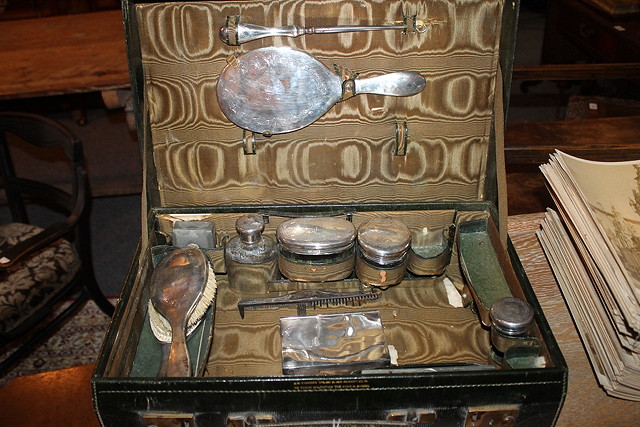 Appraisal: A LEATHER VANITY CASE with various silver topped and other