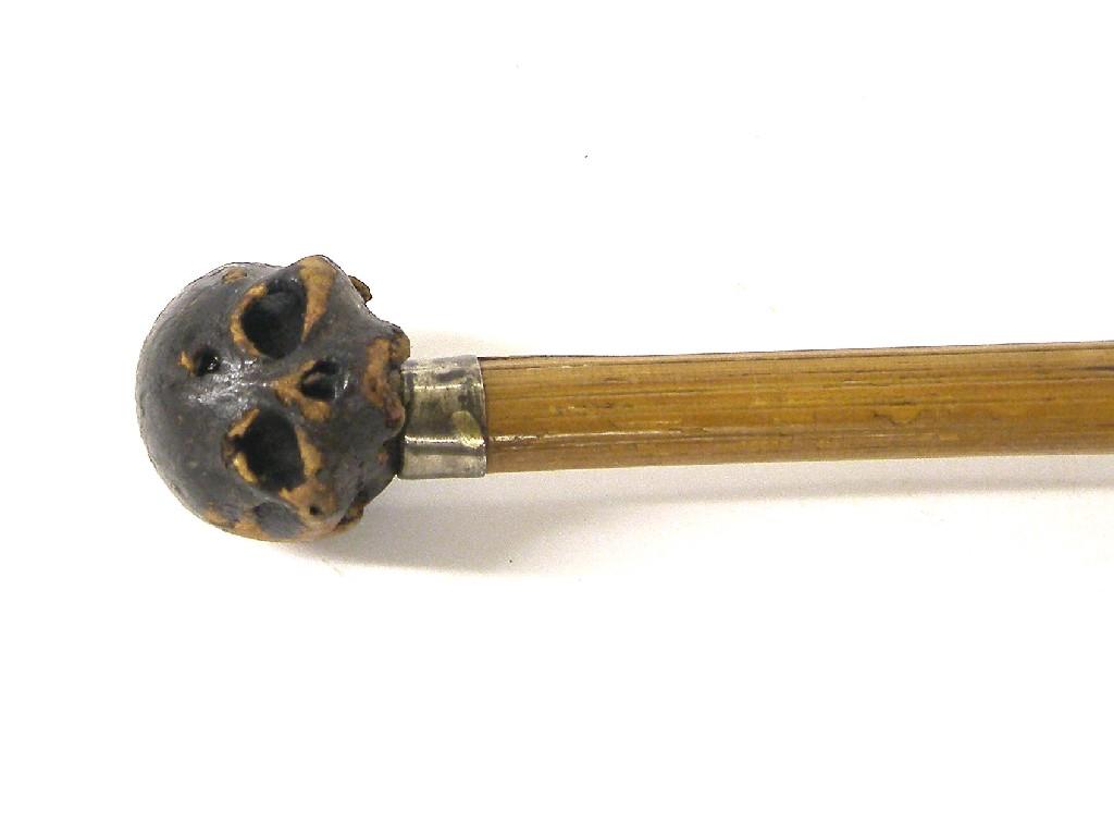 Appraisal: Bamboo walking cane the moulded skull finial over a silver