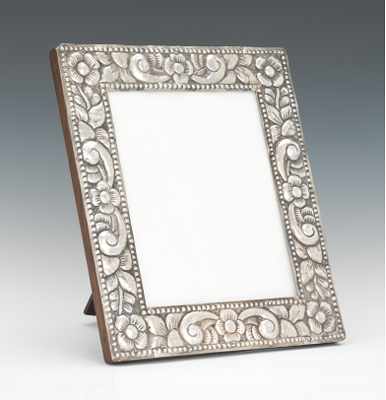 Appraisal: A Table Top Picture Frame with Silver Repousse Decoration Deep