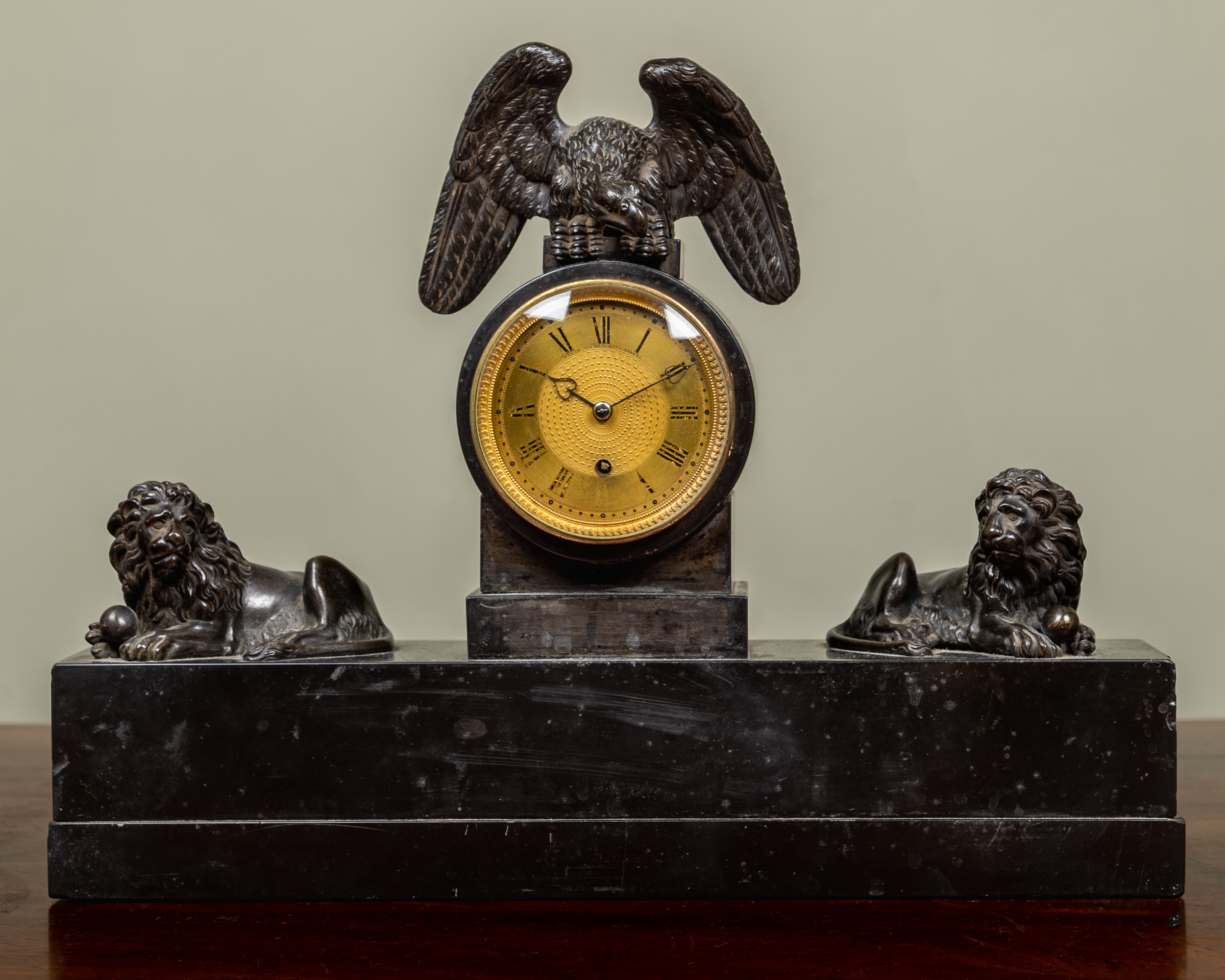 Appraisal: An early th century polished slate and bronze mantle timepiece