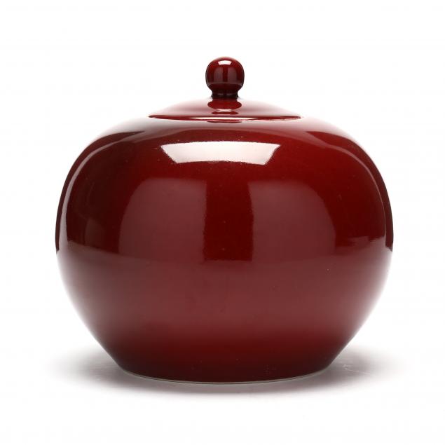 Appraisal: AN ASIAN STYLE PORCELAIN OXBLOOD RED JAR WITH COVER Contemporary