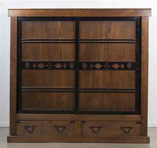 Appraisal: A Japanese Tansu of rectangular form having two sliding doors