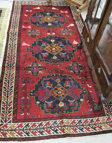 Appraisal: PERSIAN TRIBAL AREA RUG tribal medallion stylized bird and flower