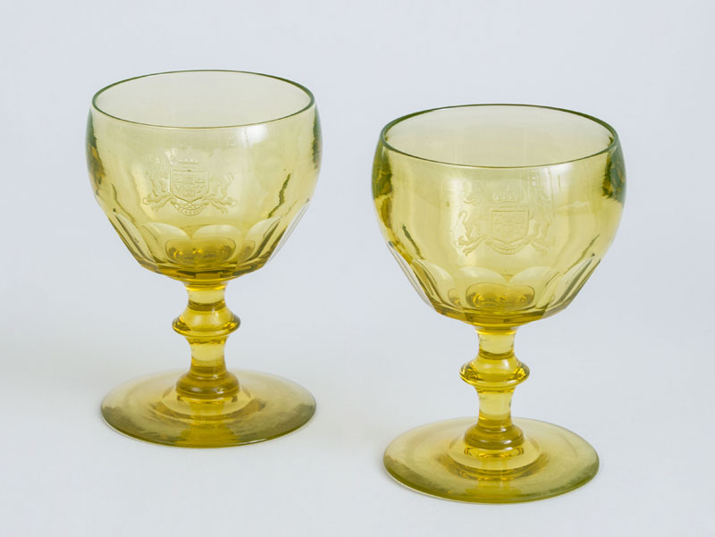 Appraisal: PAIR OF ANGLO-IRISH ARMORIAL ENGRAVED YELLOW WINE GLASSES Each faceted