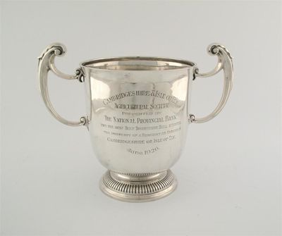 Appraisal: A modern two handled trophy cup with ribbed foot inscribed