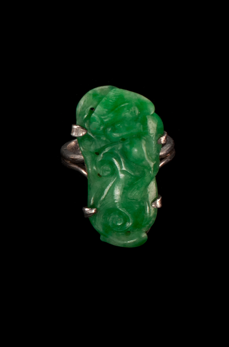 Appraisal: GREEN JADE RING Carved in qilong form In a silver