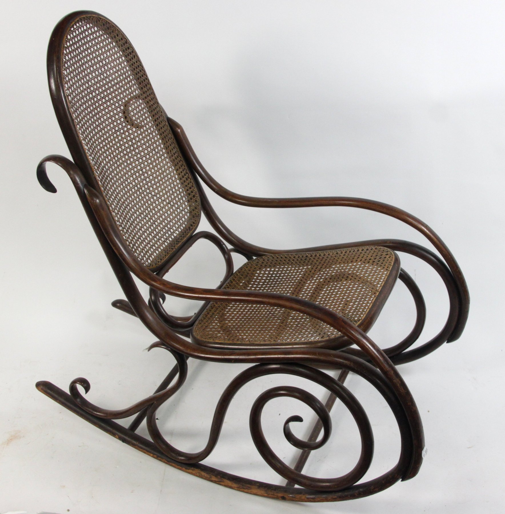 Appraisal: A bentwood rocking chair in the style of Thonet