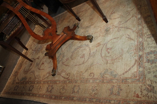 Appraisal: A PERSIAN STYLE PALE CREAM GROUND RUG with trailing foliate