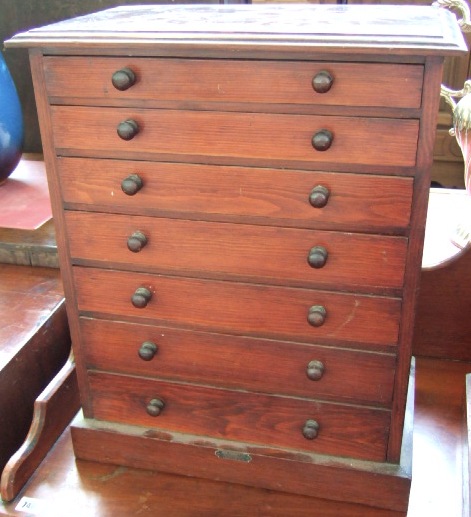 Appraisal: A stained pine table top collectors cabinet of seven long