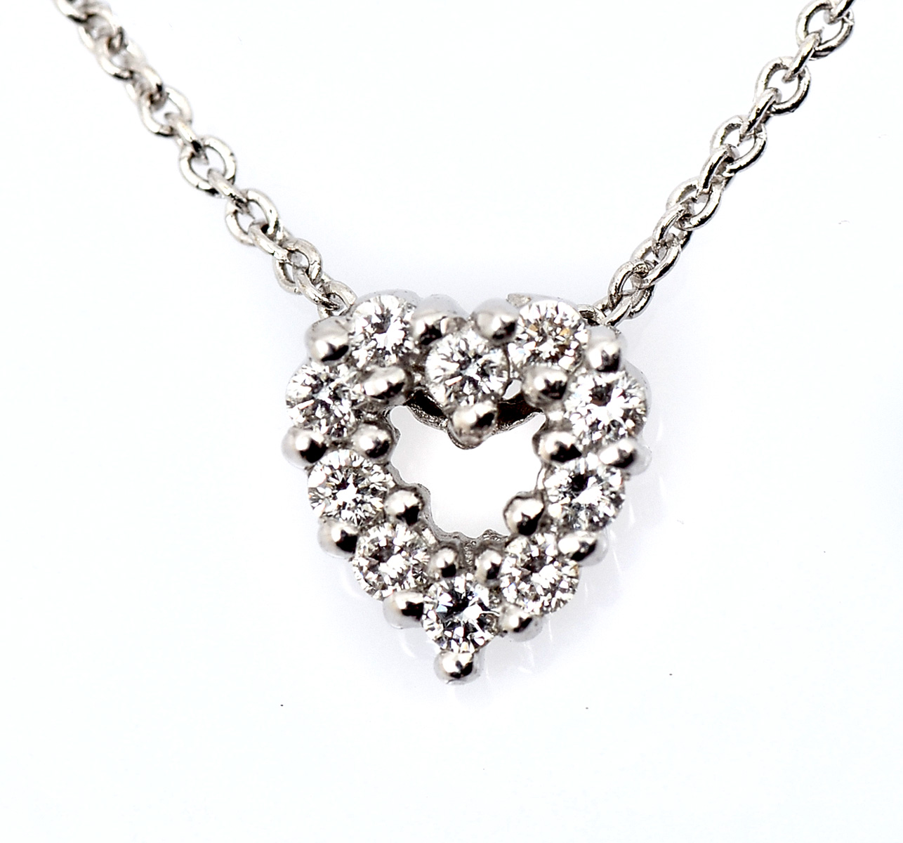 Appraisal: K PETITE HEARTSHAPED DIAMOND PENDANT WITH CHAIN near colorless diamonds