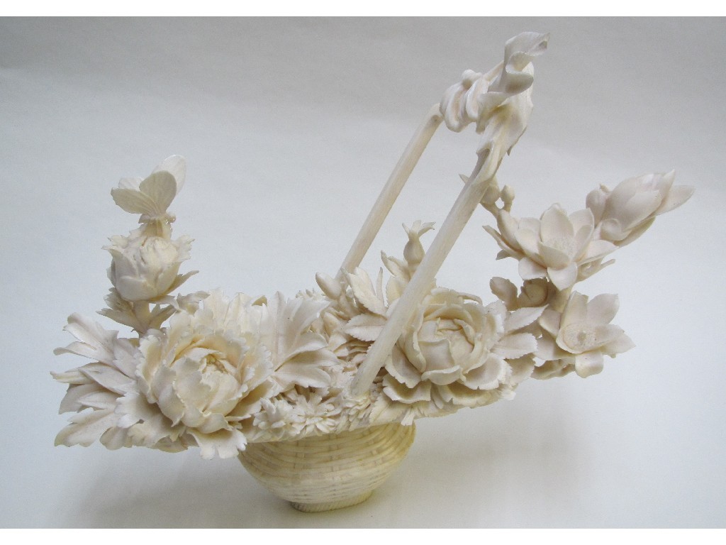 Appraisal: A Chinese carved ivory basket of flowers in high relief