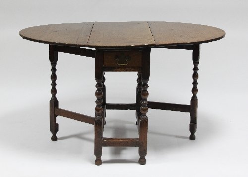 Appraisal: An oak gateleg table on turned legs and gates circa