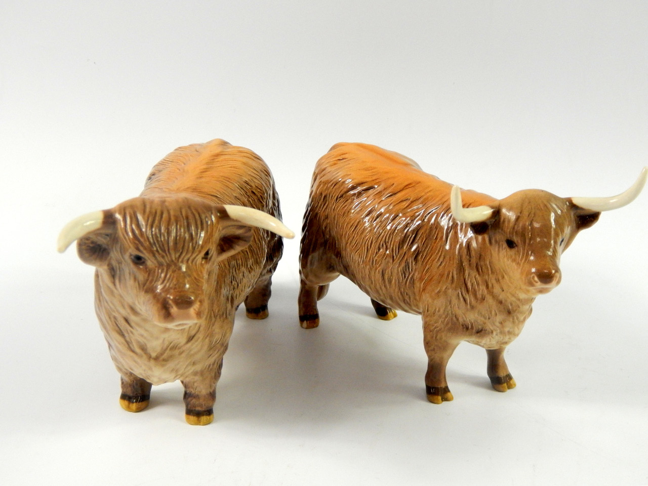 Appraisal: A pair of Beswick figures of a longhorn bull and