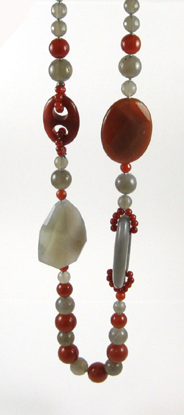 Appraisal: AGATE BEAD NECKLACE with carved and shaped beads in gray