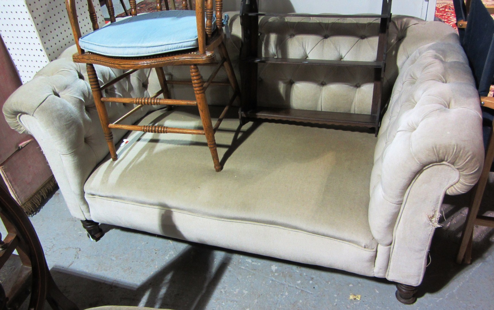 Appraisal: A Chesterfield style button back drop end sofa