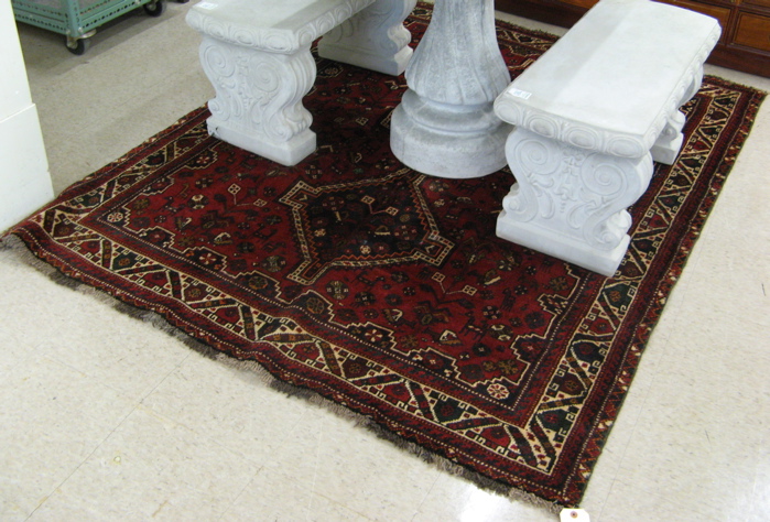 Appraisal: PERSIAN SHIRAZ AREA RUG centering three square pole medallions on