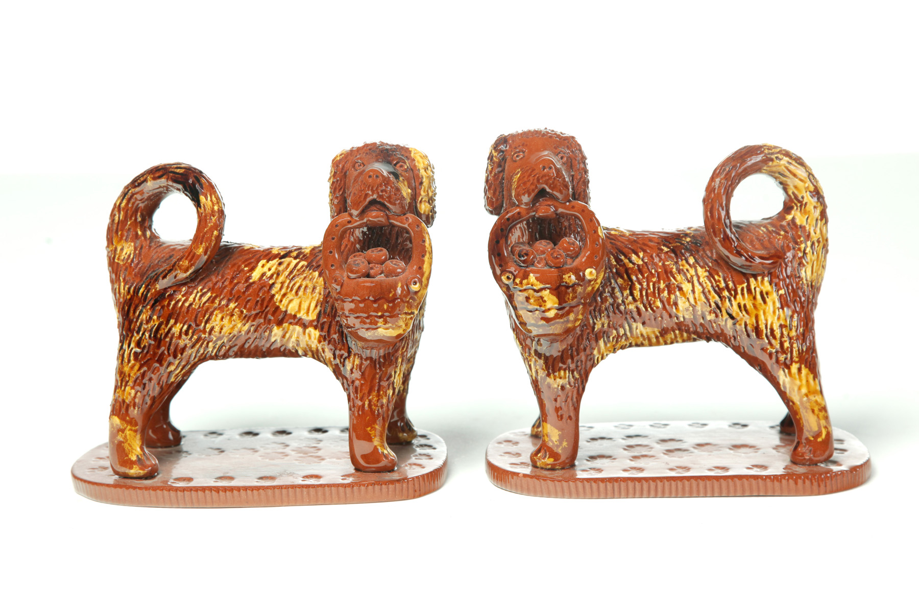 Appraisal: MIRRORED PAIR OF STANDING DOGS WITH BASKETS OF FRUIT American