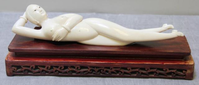 Appraisal: Carved Medicine Lady Reclining medicine lady on fitted stand From