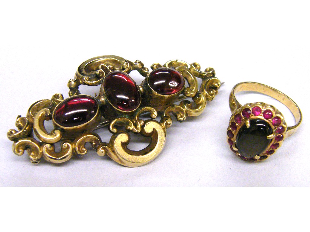 Appraisal: Victorian gold scroll work brooch set with three cabouchon garnets