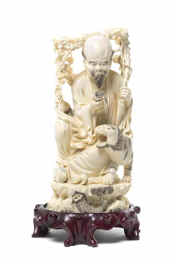 Appraisal: A Chinese Ivory Carving of Shoulao with a Tiger showing