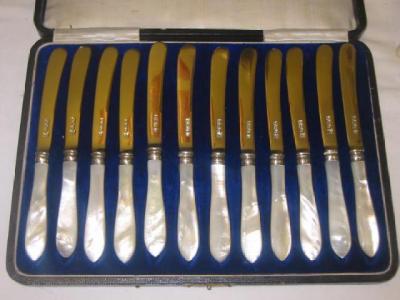 Appraisal: A SET OF TWELVE CAKE KNIVES with mother of pearl