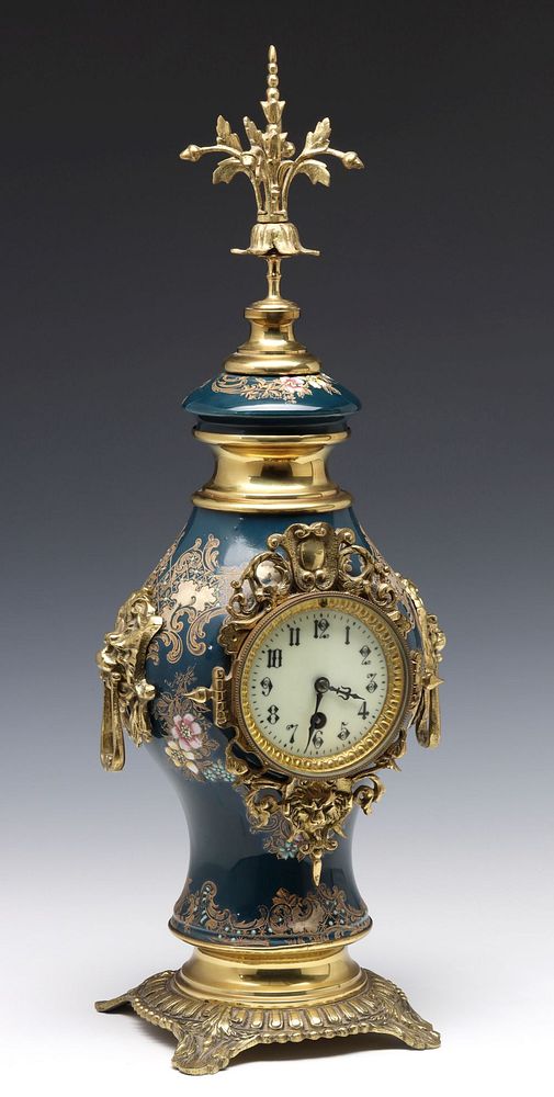 Appraisal: A CONTINENTAL PORCELAIN URN SET WITH FRENCH CLOCK The porcelain