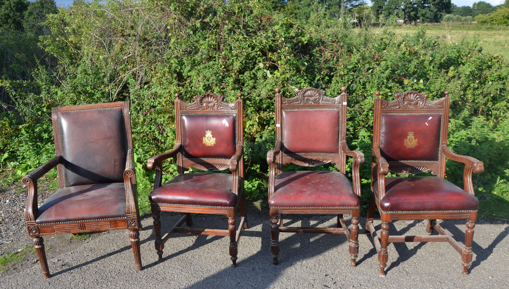 Appraisal: Set of three carved wood armchairs with shell motif to