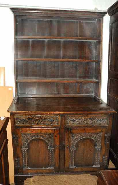 Appraisal: A TH CENTURY STYLE OAK DRESSER with three shelf plate