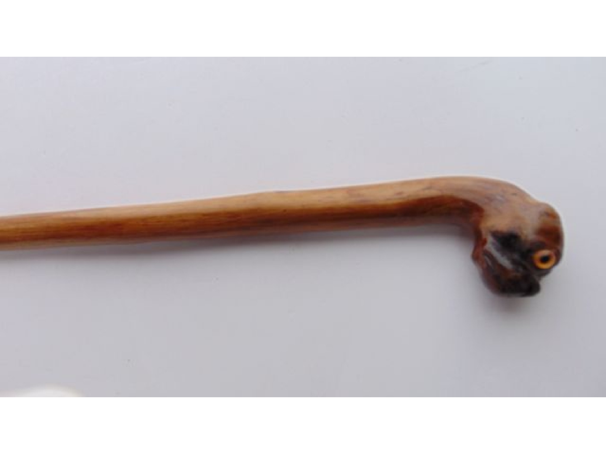 Appraisal: A worked timber walking cane the knopped handle carved in