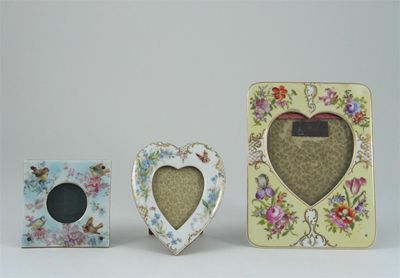 Appraisal: Three porcelain frames one decorated with songbirds the others with