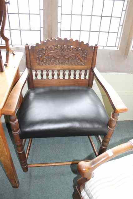 Appraisal: A CONTINENTAL CARVED ELBOW CHAIR with panel and spindle back