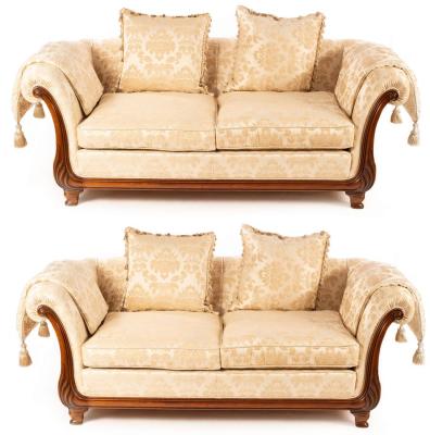 Appraisal: A pair of Victoria furniture two-seat sofas with carved scroll