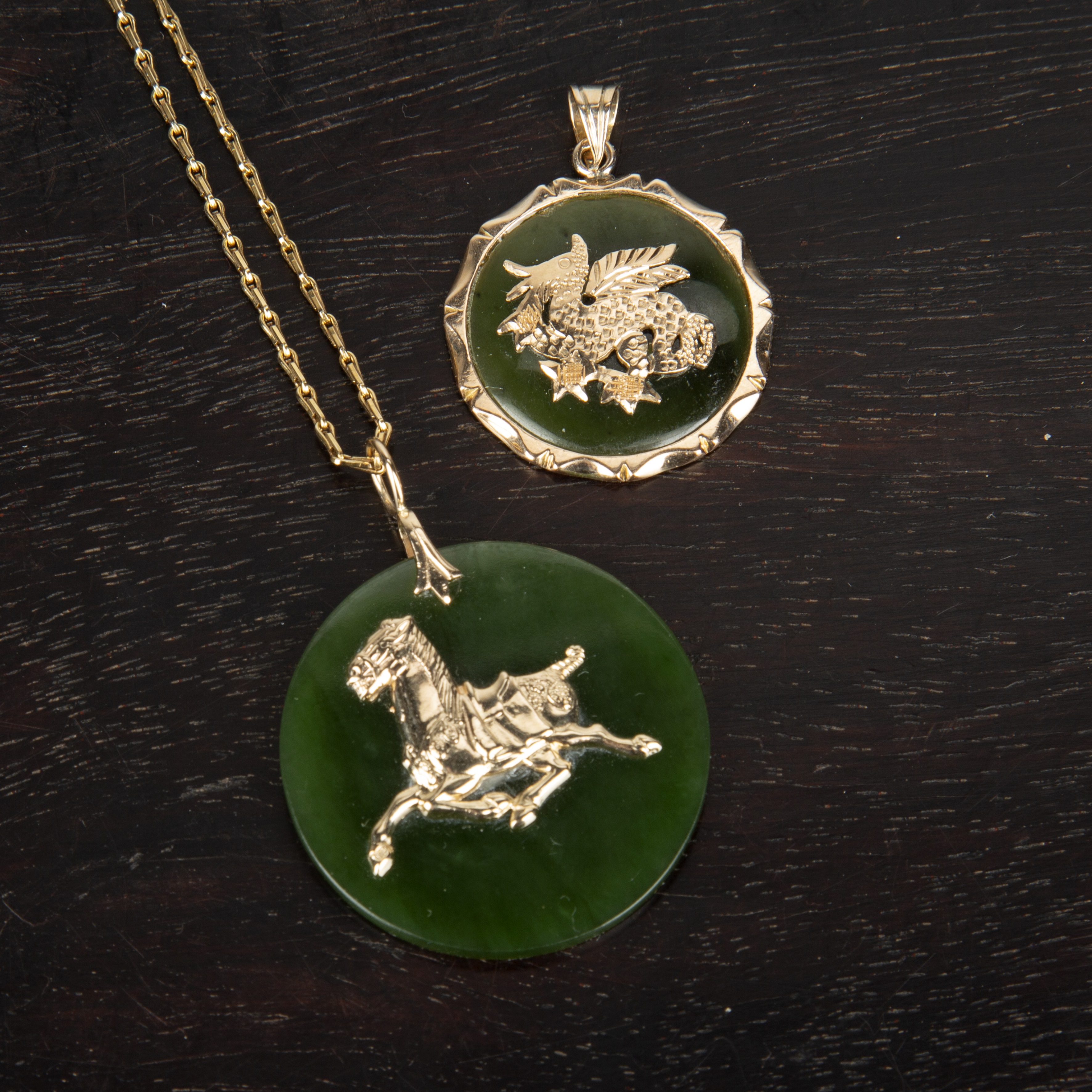 Appraisal: Two Chinese pendantsContemporary one a circular green hardstone disc decorated