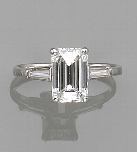 Appraisal: centering an emerald-cut diamond weighing carats flanked by two baguette-cut