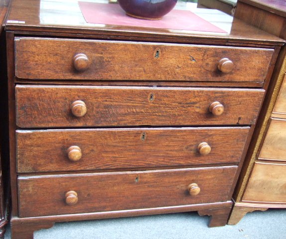 Appraisal: An th century chest of four long graduated drawers raised