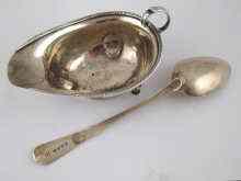 Appraisal: A silver sauceboat Birmingham together with a Georgian silver tablespoon